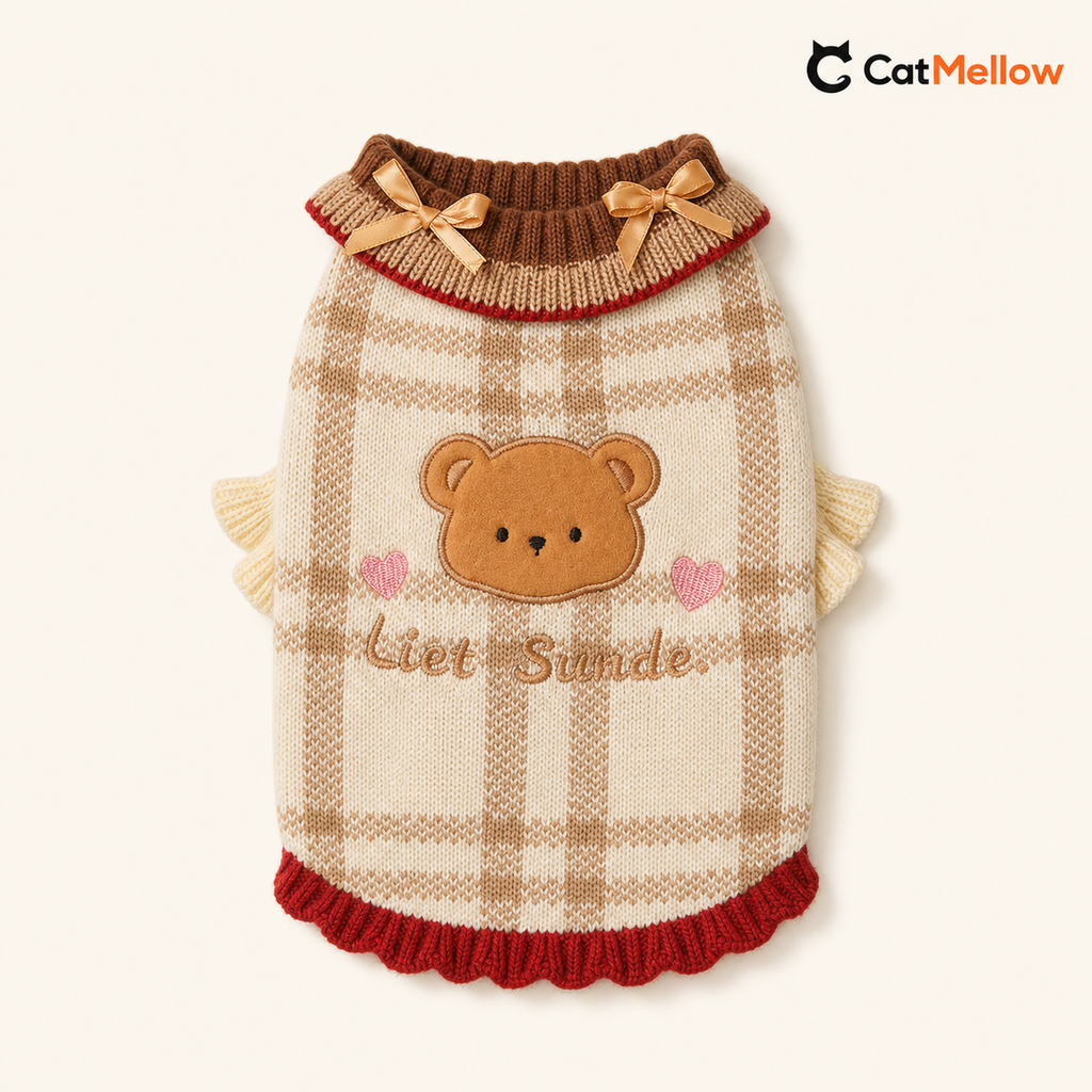Cream and brown plaid knitted cat sweater with bear applique, tan bows, and red trim.