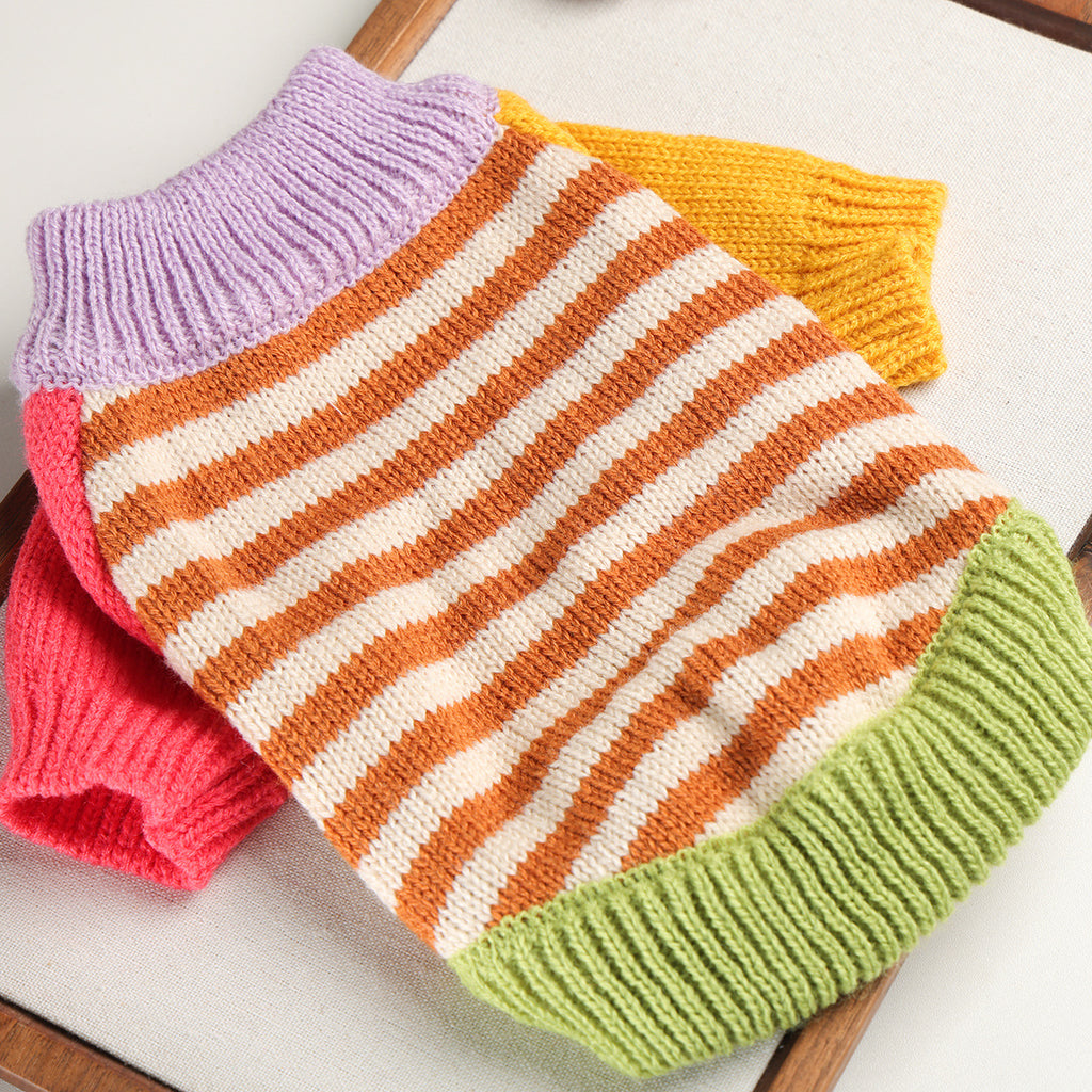 Color-block striped knit cat sweater laid flat to show the yarn texture.