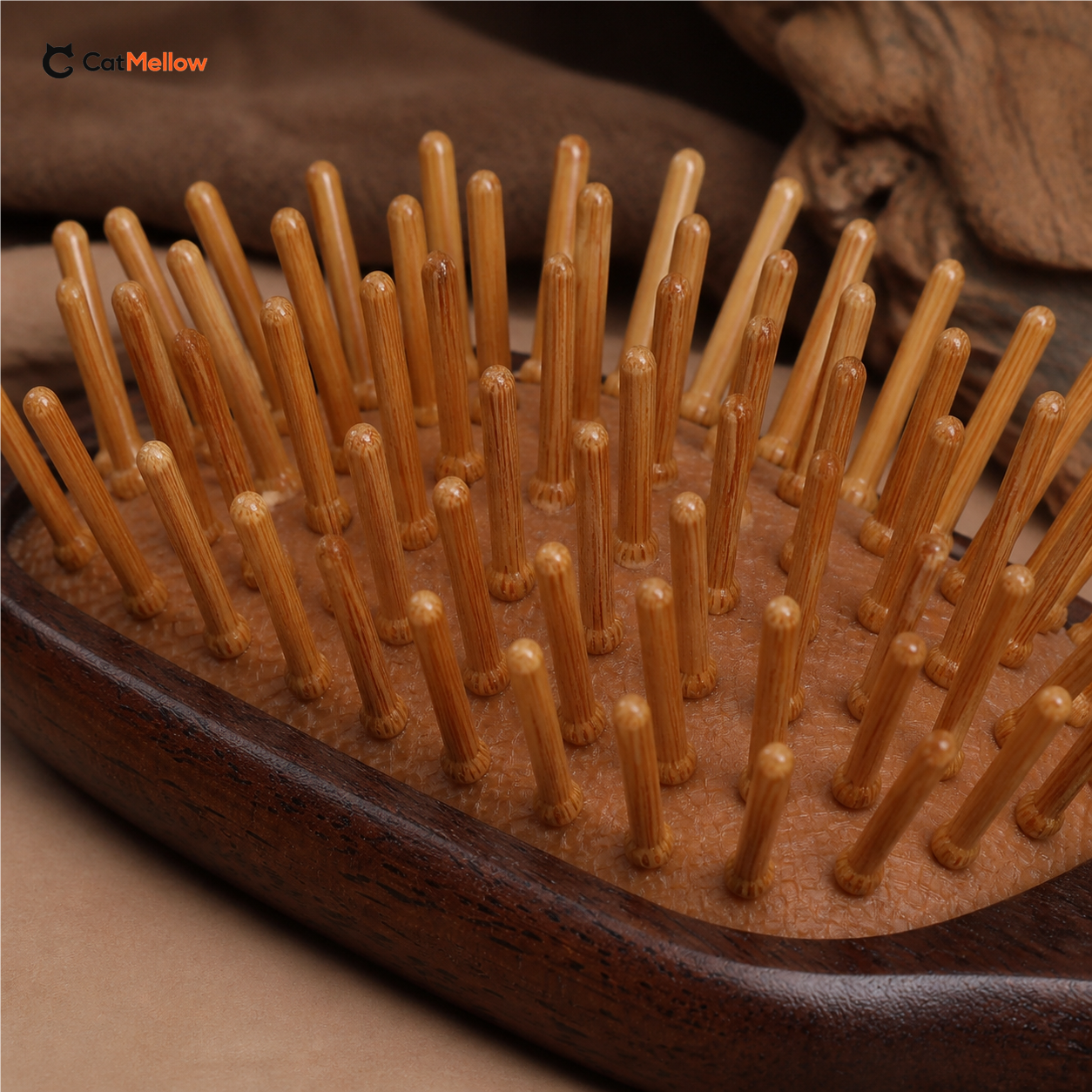 Macro view of the brush's rounded bamboo pin tips and dark wood body.