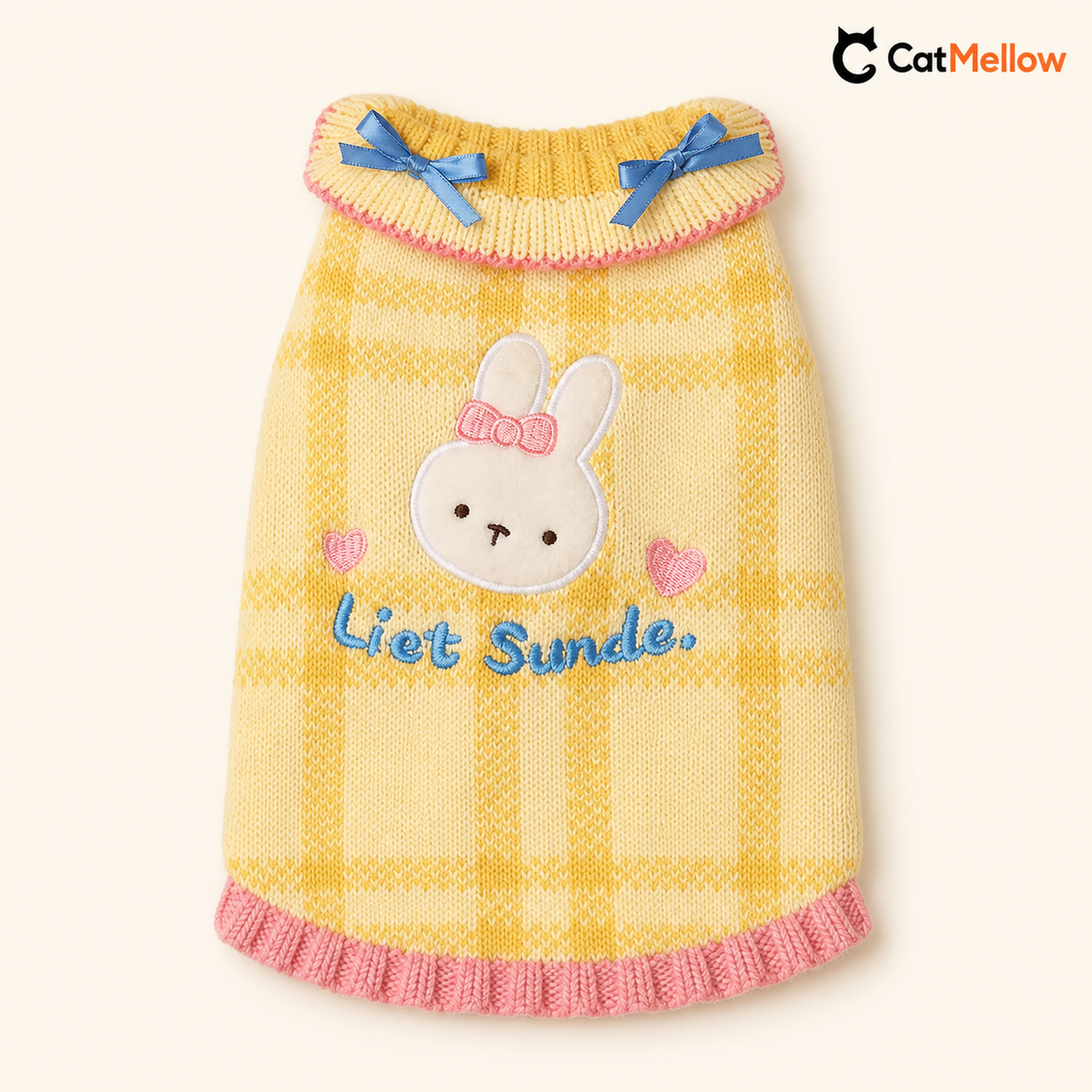 Yellow plaid knitted cat sweater with rabbit applique, blue bows, and pink trim.